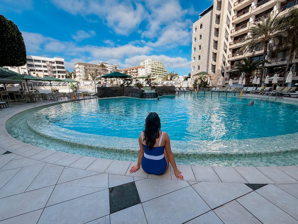 Blogger sitting by the pool at Seaside Sandy Beach